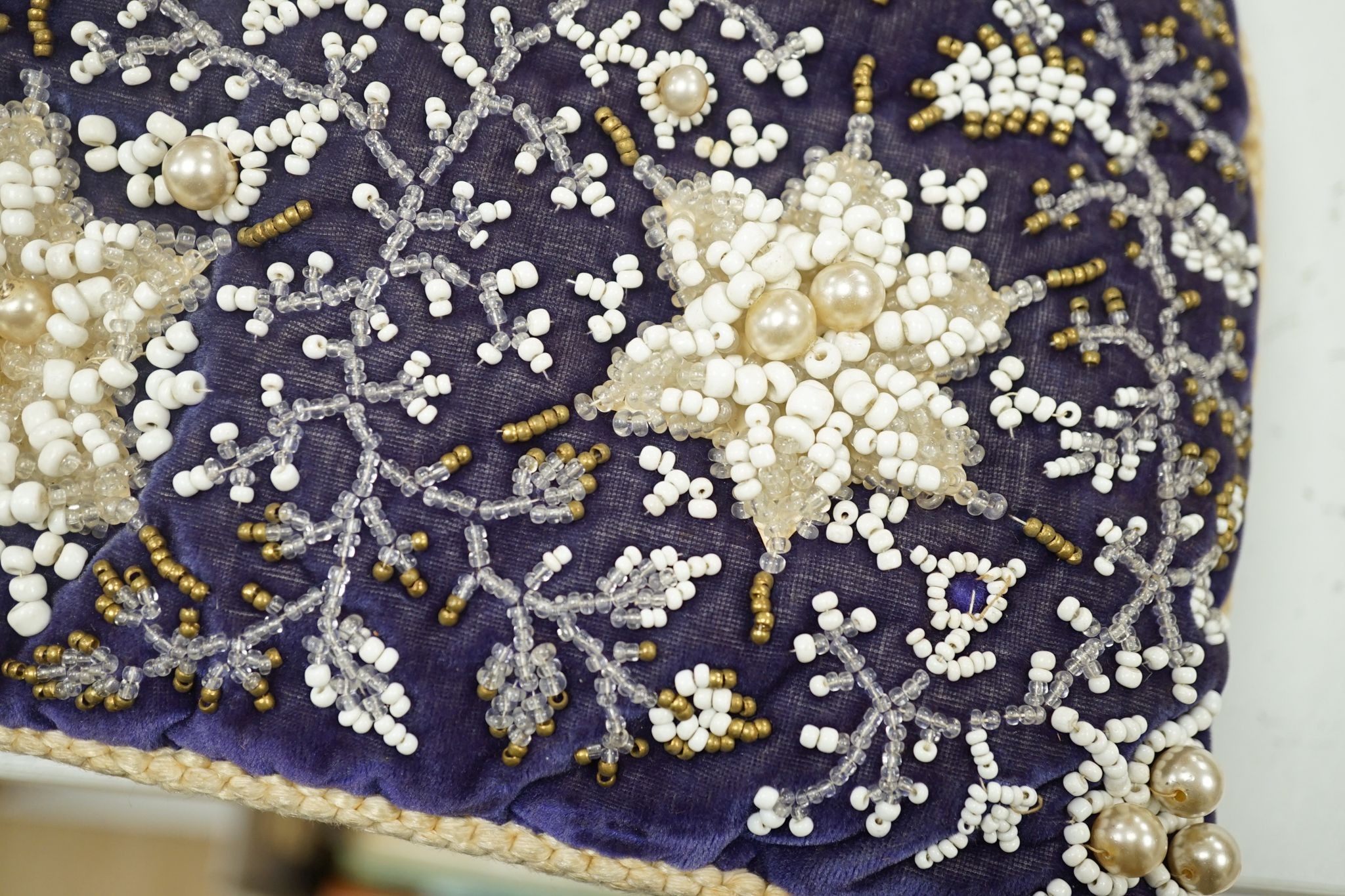 A 19th century Berlin bead worked tea cosy on purple velvet with a similar cushion, Cushion 36 cms wide x 32 high.